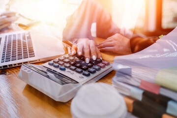 businesswoman hand working with laptop computer, tablet and smart phone in modern office with virtual icon diagram at modernoffice in morning light