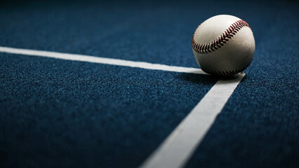 White leather baseball poses on black background.