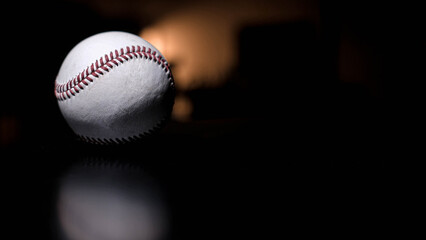 White leather baseball poses on black background.