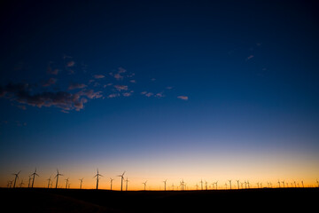 Sunset sky with wind turbines on horizon