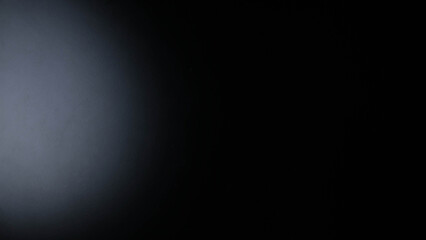 Black background with light shining on it.