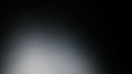 Black background with light shining on it.