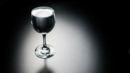 Pour pure drinking water into a glass. a glass with water set on a gray background.