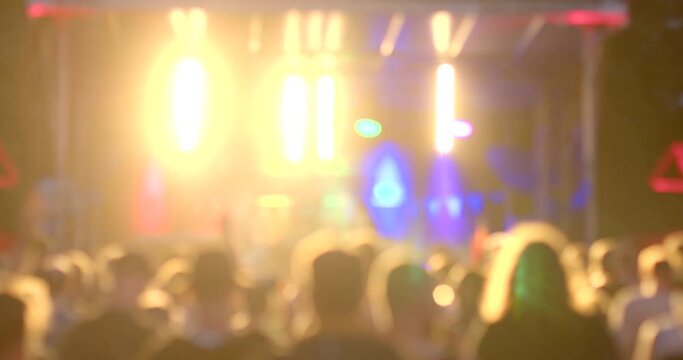 BOKE EFFECT SCENE PERFORMANCE AT A MUSIC FESTIVAL. The light is flashing, the mood is changing, people are moving, creating a mood for the viewer. Dynamic background.