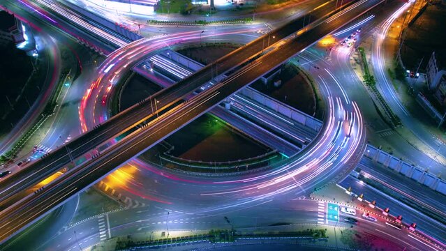 Aerial view of car traffic transportation above circle roundabout road in Asian city. Drone aerial view fly in circle, high angle. Public transport or commuter city life concept of economic and energ	