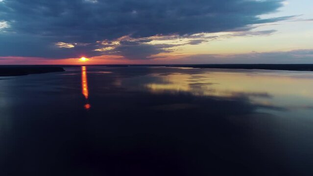 Aerial view. Amazing sky reflected in water. Beautiful sunset over the lake.