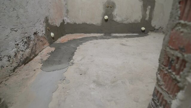 Bathroom floor renovation. Refurbish and refurbish the bathroom. Concrete floors in the bow building. Concrete floor in a new apartment, bathroom.