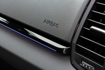 Close-up of airbag sign on dashboard. Car interior.