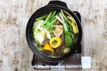 Bone Marrow Bulalo Soup with corn and vegetable served in a bowl isolated on grey background side view of stewed