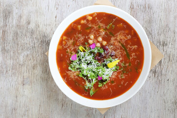 Vegetable Chickpea Minestrone Soup served in a dish isolated on grey background top view of soup