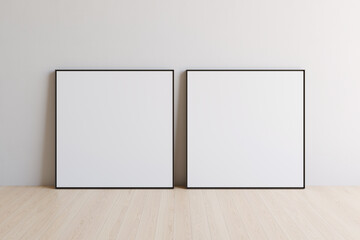 Two square blank picture canvases with thin black borders standing on wooden floor. Template for your content. 3D illustration.