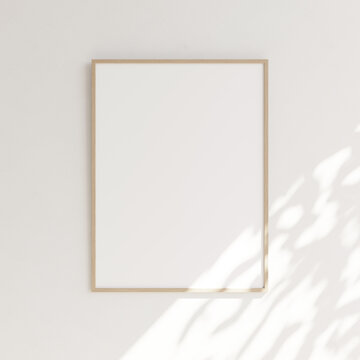 Blank picture with wooden frame, white canvas on white wall partially illuminated by sun rays. Template for your content. 3D illustration.