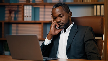 Fototapeta na wymiar Tired sad businessman sitting in office sleepy exhausted african american male manager professional worker falls asleep at workplace napping leaning on arm feeling fatigue exhaustion from overwork