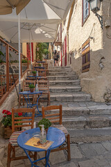 Intimate, tranquil and sunlit street located at the foothill of Acropolis, Athens, Greece.