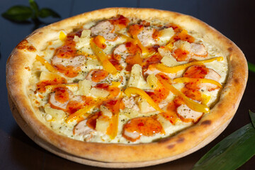 Tasty pizza and cooking ingredients tomatoes basil on black concrete background. Top view of hot pepperoni pizza. 