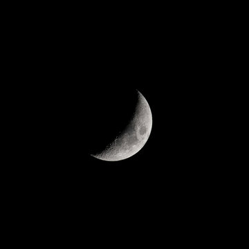 Crescent moon shining bright in the dark night sky 