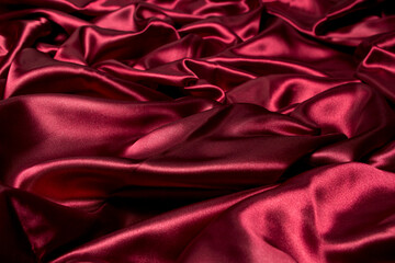 Crumpled red fabric as a background for the image. Texture of red textile material