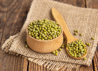 Close-up mung beans .Green mung beans in a wooden bowl on an old table