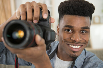 portrait of male photographer holding digital camera