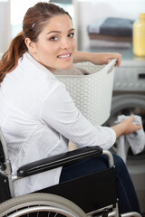 happy disable woman carring a basket to do laundry