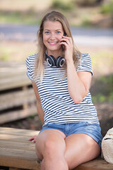 happy young woman smiles and talking on the phone