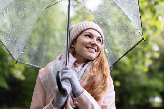 portrait of woman holding transparent umbrella