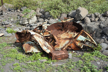 Old car wreck. We see crumpled sheets with rust on them.