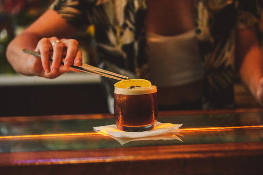 PREPARED COFFEE DRINK WITH COFFEE LIQUOR, AND A SLICE OF ORANGE. CARAJILLO OF A BAR IN THE BAR.