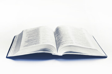 An open Bible on a white background. Scripture