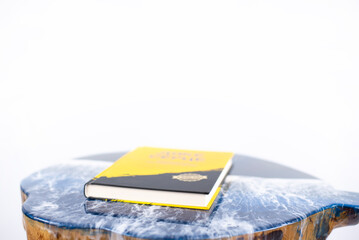 The book is on the table. Table made of epoxy resin. On a white background.