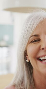 Vertical video portrait of half face of happy senior caucasian woman laughing, with copy space