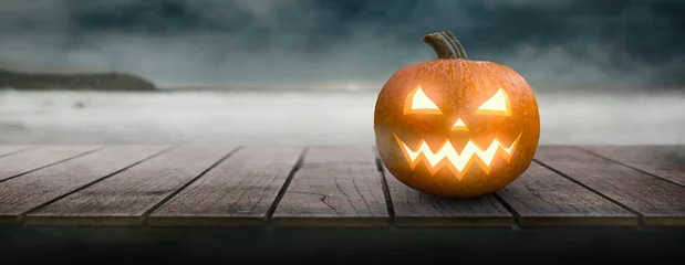 Fotobehang spooky pumpkin on a halloween night table - copy space © Jess rodriguez