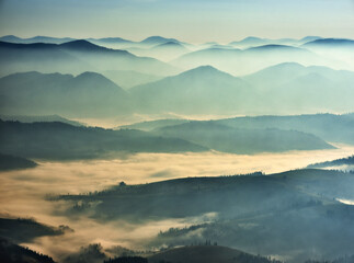 Predawn time in the highlands. mountain silhouettes in the fog. Nature of Ukraine
