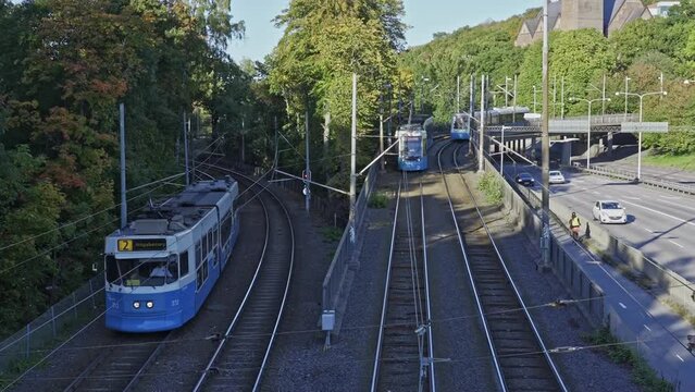 Blue tram moving on the tracks. Means of transport circulate in peripheral areas of the city. Tramways of Gothenburg. Order and respect for timetables. Slow motion.