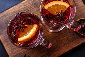 Hot mulled wine with a slice of orange, with cinnamon, cloves and other spices
