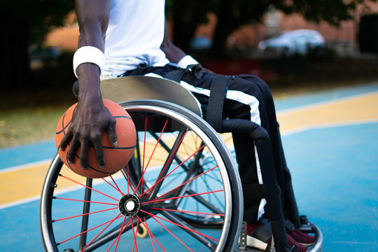 Close Up Of Invalid Basketball Player Sitting On A Wheel Chair Outdoors