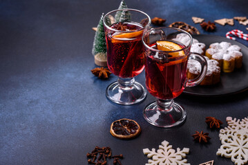 Hot mulled wine with a slice of orange, with cinnamon, cloves and other spices