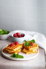 Belgian waffles in white plate raspberry mint breakfast
