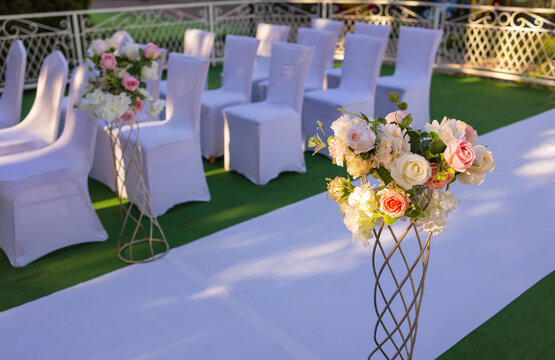 White Chairs With Pink Bows For Wedding Exit Registration.