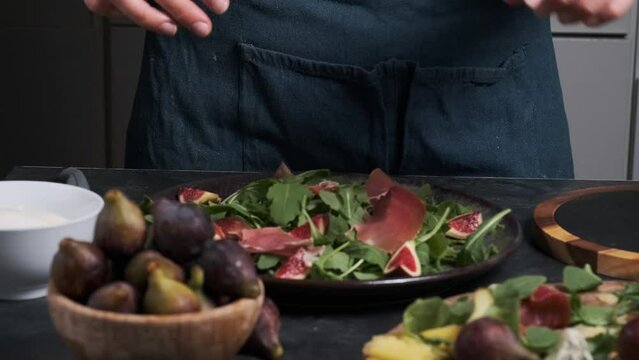 women's hands make fresh salad