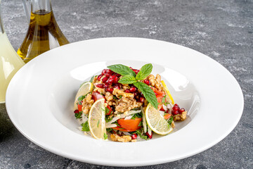 Gavurdağı Salad - Traditional Turkish Walnut Salad with Vegetables served with lemoon and salad dressings.