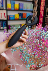 Girl's hand holds a massager for sex. Vibrator for masturbation. Dildo for vaginal and clitoral...