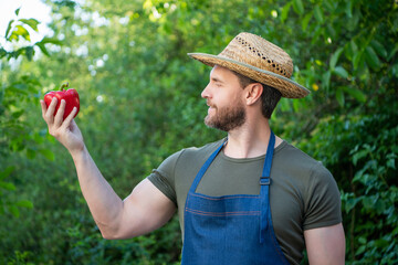 farmer villager in straw hat with sweet pepper