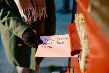 Close up of woman posting letter to Santa Claus.