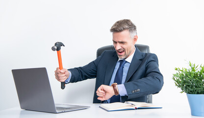 frustrated boss hitting laptop with hammer and checking time