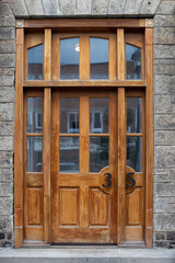 A beautiful wooden door and windows at the entry to a historic building