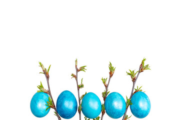 Young spring branches with green leaves with easter blue eggs