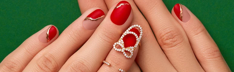  Womans hand with fashionable red manicure close up. Manicure, pedicure beauty salon concept. © Darya Lavinskaya