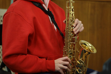 The person in red playing the saxophone