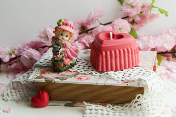Fototapeta na wymiar valentine's day background. handmade soy candle made of natural soy wax in the shape of a red heart 